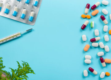 Concept of medicines, medical supplies placed on a blue background.